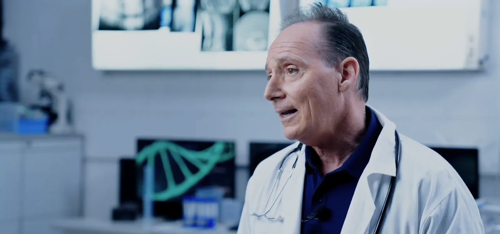 Paul Donnelly, retired physician assistant, in a white coat in a clinic